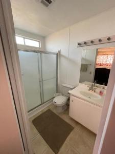 a bathroom with a toilet and a sink and a mirror at Casa Isabel in Ensenada