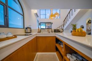 a kitchen with a sink and a counter top at Breezy villa w- pool & beach access in Mengwi