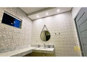 a bathroom with a sink and a mirror at Hotel El Shaddai in Pontes e Lacerda +18 photos