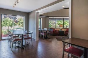 a dining room and living room with a table and chairs at Comfort Inn Cobourg - Port Hope in Cobourg +10 photos