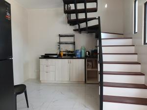 a kitchen with a spiral staircase in a room at A Peaceful House in Mexico