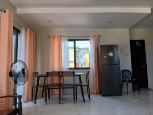 a kitchen with a table and chairs and a refrigerator at A Peaceful House in Mexico +1 photo