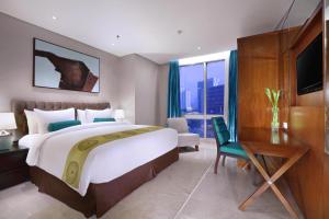 Postelja oz. postelje v sobi nastanitve The Grove Suites by Grand Aston