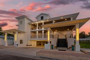 a large white building with a sunset in the background at Grant Street Inn, an Ascend Collection Hotel in Dunedin