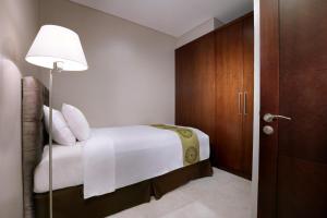 Postelja oz. postelje v sobi nastanitve The Grove Suites by Grand Aston