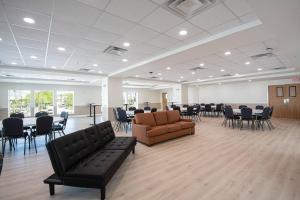 a large room with a waiting room with chairs and couches at The J Hotel Dunedin Clearwater, an Ascend Collection Hotel in Dunedin +53 photos