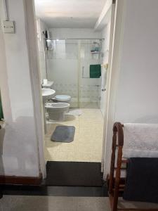 a bathroom with a shower and a toilet and a sink at Verandah 46 Homestay Kandy in Katugastota