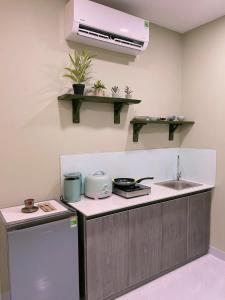 a kitchen with a sink and a counter top at Bống's Homesray and café in Ho Chi Minh City +35 photos