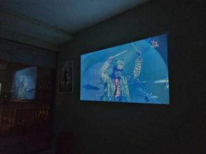 a flat screen tv hanging on a wall at Bống's Homesray and café in Ho Chi Minh City