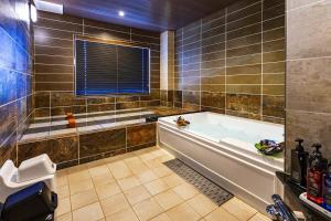 a large bathroom with a tub and a window at Hotel PALM GATE in Fukuoka +117 photos