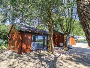a wooden house with trees in front of it at Fern in Barnstaple
