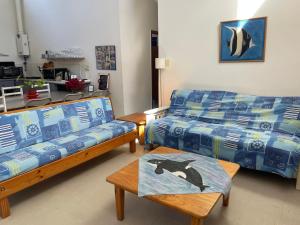 a living room with a couch and a table at lagoon Breeze in Langebaan