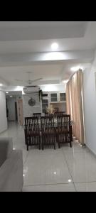 a living room with two benches and a table at Masterkey stay in Kakkanad