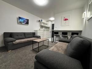a living room with a couch and a table at SANSET APART Okuninka in Okuninka