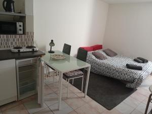 a small kitchen with a table and a couch at studio stella in Sospel