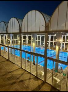 a view of a swimming pool at night at Balansea Resort in Caesarea