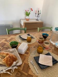 a table with a loaf of bread on top of it at Les Toits d'Aniane in Aniane +16 photos