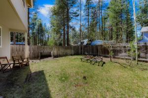 a yard with benches and a fence and trees at Royal Retreat Quiet & Cozy in South Lake Tahoe