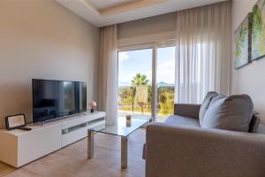 a living room with a couch and a television at Nicolas in Casas Devesa
