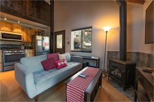 a living room with a couch and a stove at Tramway Haus Mountain Views in Stateline