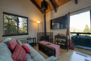a living room with a couch and a fireplace at Tramway Haus Mountain Views in Stateline