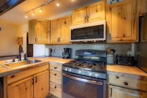 a kitchen with wooden cabinets and a stove top oven at Tramway Haus Mountain Views in Stateline