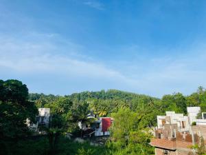 a group of buildings on a hill with trees at Shanuka homes in Mawanella
