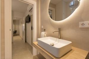 a bathroom with a white sink and a mirror at Apartamento Silleria Reyes Catolicos Centro in Granada +19 photos
