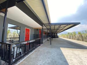 a train station with a red door and a building at Angkel's Place in Bangued