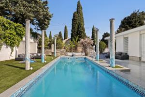 a swimming pool in a yard with trees at Luxury suite Portorož in Portorož
