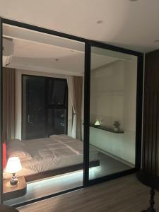 a bedroom with a bed and a large glass window at Cherry Home in Ðan Phô
