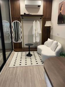a living room with a white couch and a chair at Cherry Home in Ðan Phô
