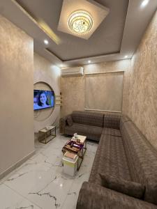 a living room with a couch and a tv at شقق مباركية in Rafha