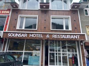 a building with a sign that reads sonnar hotel and restaurant at Hotel Sounsar and Restaurant in Sonāmarg