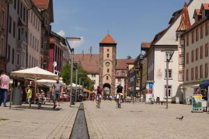 a group of people riding bikes down a city street at Loft Style Studio - historic old town in Villingen-Schwenningen