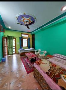 a living room with green walls and a couch at PeaceVibe Homestay in Uttarkāshi