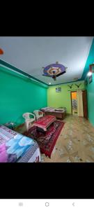 a room with two beds and a ceiling at PeaceVibe Homestay in Uttarkāshi +11 photos