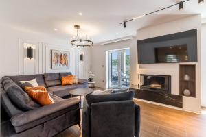 a living room with a couch and a fireplace at Countryside family villa with pool Zmina in Donji Muć