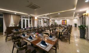 a restaurant with wooden tables and chairs in a room at Sapa Signature Inn in Sapa