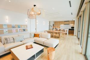a living room with a couch and a table at SHIMASTREAM house in Shodoshima +50 photos
