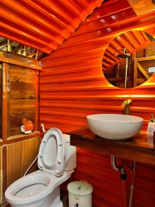 a bathroom with a toilet and a sink at JoyStay in Cat Ba