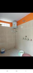 a bathroom with a pink toilet and a sink at PeaceVibe Homestay in Uttarkāshi