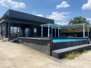 a building with a swimming pool in front of it at Angkel's Place in Bangued
