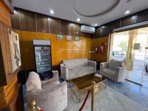 a living room with two chairs and a fireplace at شقق مباركية in Rafha