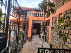 an entrance to an orange building with a gate at Torchys in Kisumu