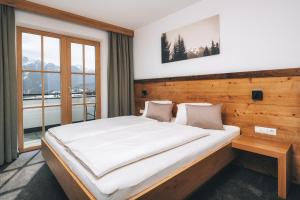 a bedroom with a large bed in front of a window at Appartements Alexander in Fiss
