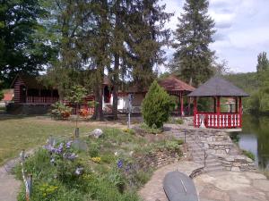 a garden with a gazebo next to a lake at Tiny Guesthouse Kamptal in Schonberg am Kamp