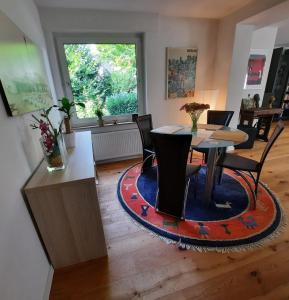 a dining room with a table and chairs and a window at Modern apartment Selm Cappenberg in Selm