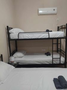 a couple of bunk beds in a room at Mani GuestHouse in Kyparissos