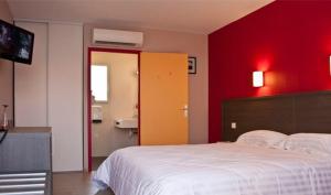 a bedroom with a white bed and a red wall at Hôtel Cantal Cottages in Saint-Georges